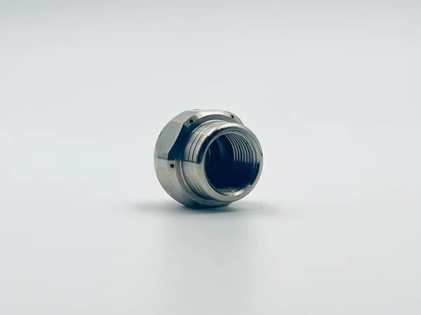 Side profile of Bullet Mini Nozzle showing compact mounting hardware and threaded inlet connection points suitable for various fluid handling system applications.