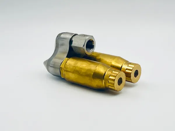 "Close up view showing dual outlet spray pattern and rotation mechanism on the main body of industrial fire sprinkler head unit"
