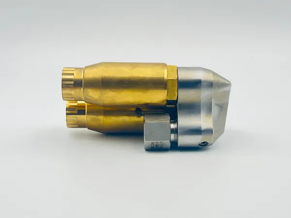 "Side profile highlighting mounting hardware details and connection points on the Reverse Rotary Dual Outlet nozzle assembly body"