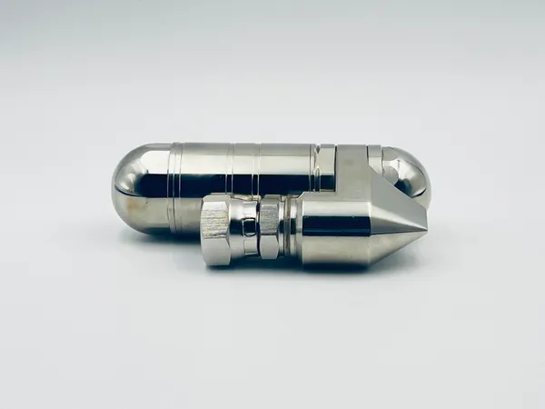 Side profile of FX-710 reverse nozzle highlighting connection ports and mounting bracket details designed for secure installation on pneumatic systems requiring precise fluid flow management specifications.