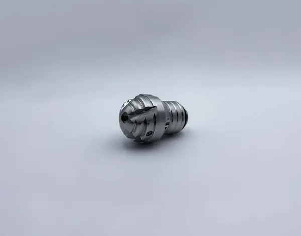 Side angle view of Tapered Bulb Nozzle showcasing inlet connection details internal valve mechanism durability metal body industrial coating applications BTDP variant