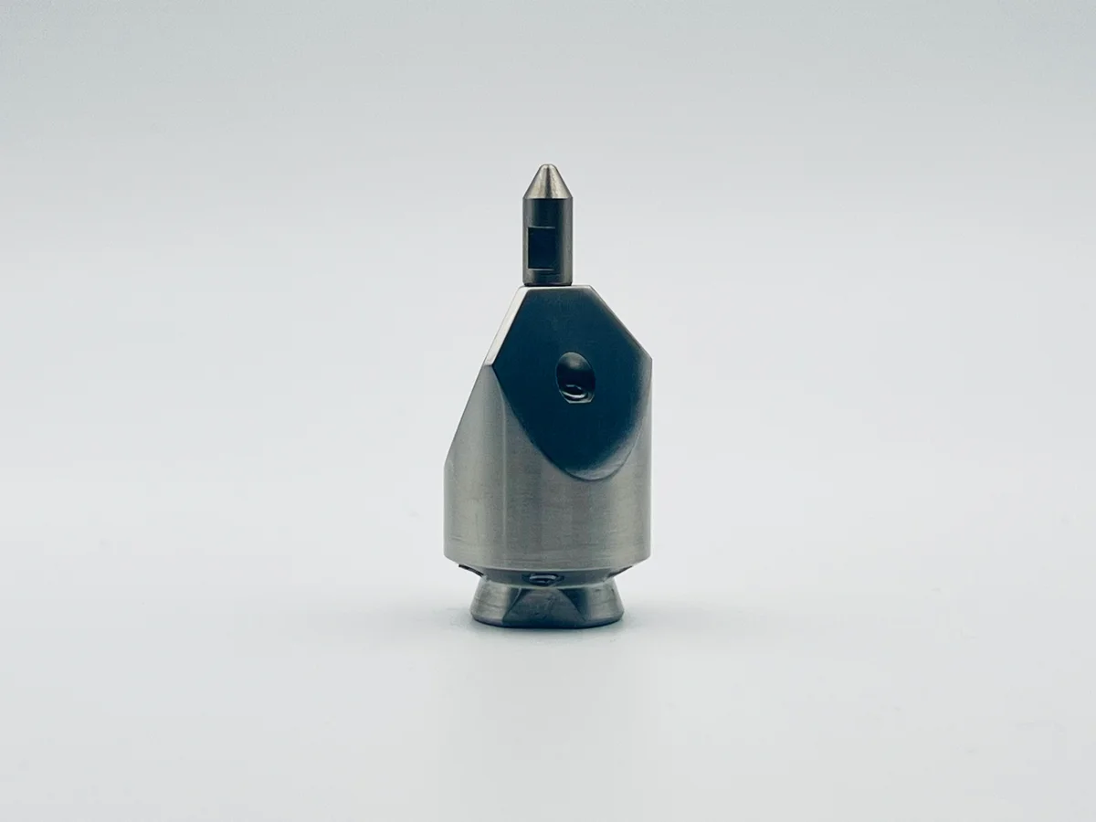 Penetrating nozzle close up of durable metal construction with threaded connections for high pressure industrial fluid transfer